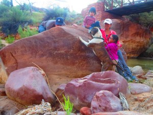 goofy self timer family photo, Aaron peaking from behind the big rock we're leaning agains and our dog is jumping up at him