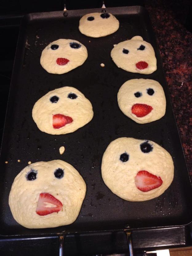 Smiley face pancakes with blueberry eyes and strawberry lips for Marley and Jackson