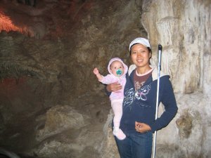 Marley on my hip, pacifier in her mouth, can in my hand inside the Lehman Caves