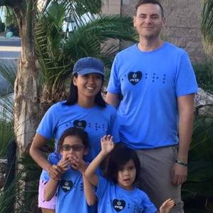 image of our family in our, "I love Braille," shirts, and the kids making silly faces of course