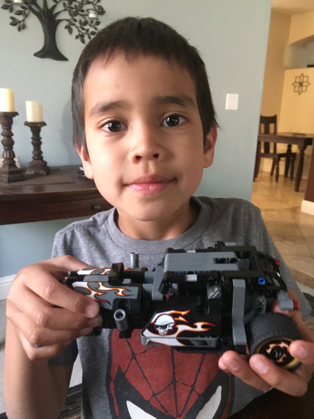 future engineer holding a lego car
