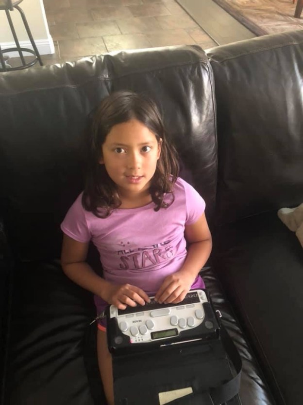 Photo of Marley writing her speech on her Braille note taker